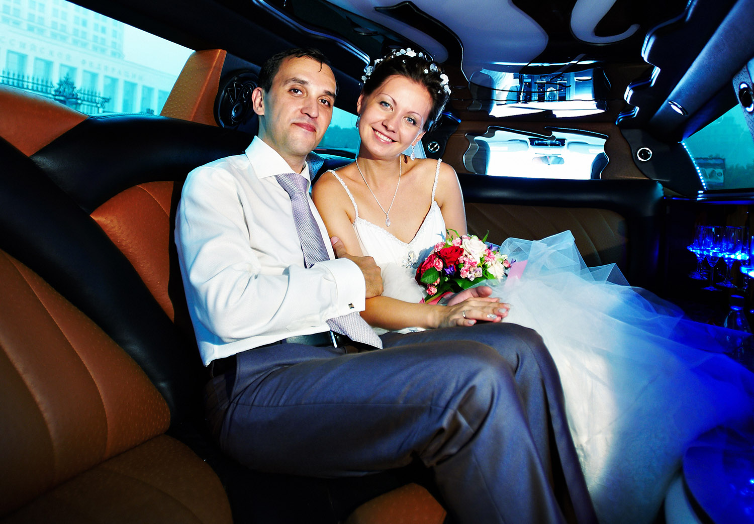 Bride and groom in limo bus