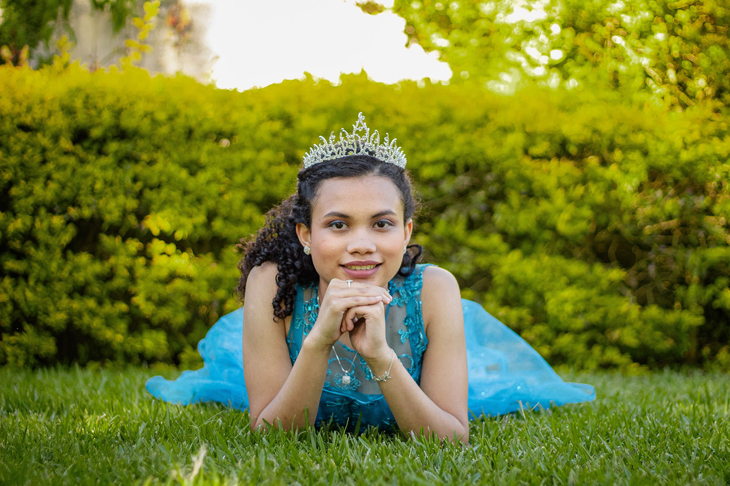 Girl in blue dress and tiara on the day of her quinceanera